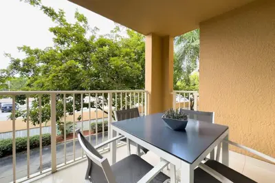 a balcony with a table and chairs on a balcony at Aventura Mall Apt with Pool a Tennis Court and Free parking in Aventura