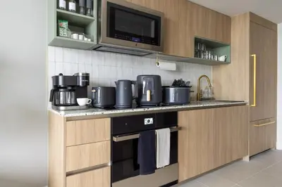 a kitchen with a stove and a microwave at 3808 Apt Next to Kaseya Center with Pool a Spa and Gym in Miami