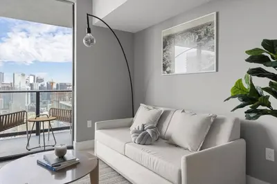 a living room with a couch and a table at 3808 Apt Next to Kaseya Center with Pool a Spa and Gym in Miami