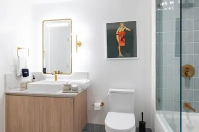 a bathroom with a sink and a mirror and a toilet at 3808 Apt Next to Kaseya Center with Pool a Spa and Gym in Miami
