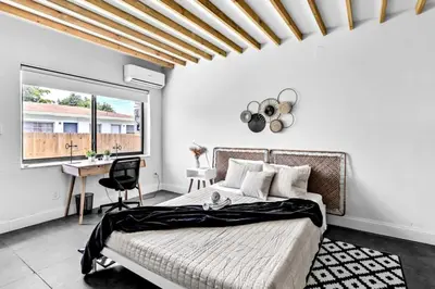 a bedroom with a bed and a desk and a window at Unit 2 Cute Studio in North Miami 10min to beach in Miami