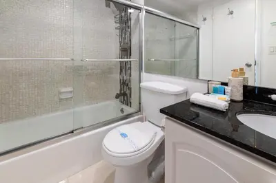 a bathroom with a toilet and a shower and a sink at Beachfront Winter Escape, Balcony with Ocean View, Amenities in Hollywood