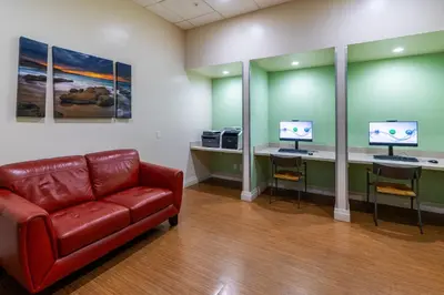 a waiting room with a couch and two computer monitors at Beachfront Winter Escape, Balcony with Ocean View, Amenities in Hollywood