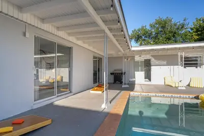 a house with a swimming pool and a patio at Tropical Retreat on Sheridan l Near Beach and Parks in Hollywood