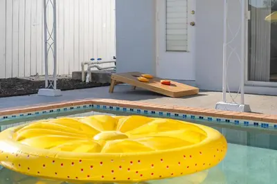 a yellow ottoman sitting in a swimming pool at Tropical Retreat on Sheridan l Near Beach and Parks in Hollywood