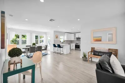 a living room with a couch and a table at Palm Haven in Fort Lauderdale