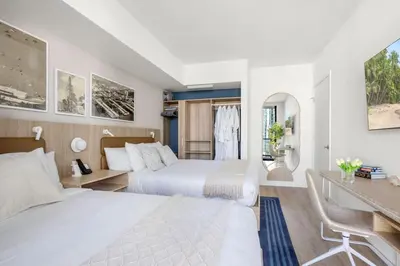two beds in a hotel room with a desk and a desk at 2002 One bedroom unit for 4 Ppl next to Kaseya Center with Gym and Pool in Downtown Miami in Miami