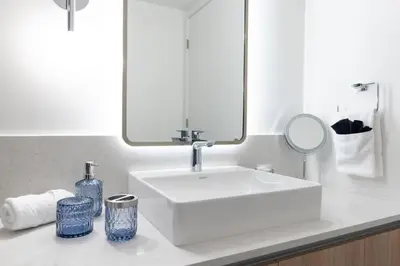 a bathroom with a white sink and a mirror at 2002 One bedroom unit for 4 Ppl next to Kaseya Center with Gym and Pool in Downtown Miami in Miami
