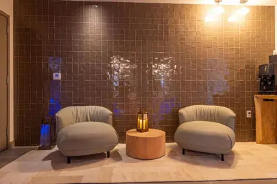 a waiting room with two chairs and a table at 2002 One bedroom unit for 4 Ppl next to Kaseya Center with Gym and Pool in Downtown Miami in Miami