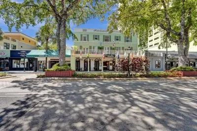 a street in front of a building with trees at Eden Collection Studio Steps to Beach in Fort Lauderdale