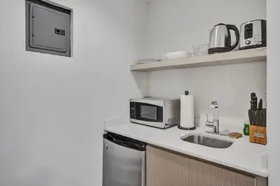 a kitchen with a microwave and a sink at Eden Collection Studio Steps to Beach in Fort Lauderdale