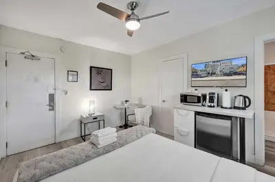 a white room with a kitchen and a living room at Eden Collection Studio Steps to Beach in Fort Lauderdale