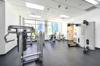 a gym with treadmills and machines in a room at Stylish Brickell Penthouse with Exclusive Perks in Miami