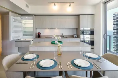 a kitchen with a dining table and chairs at Lyfe Resort & Residences By OceanMiami in Hollywood