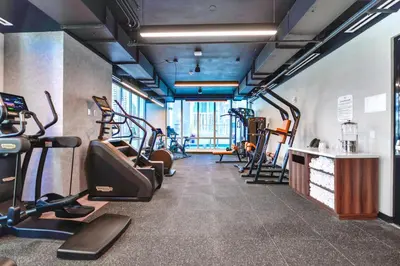 a gym with treadmills and elliptical machines at Modern Comfort by the Beautiful Bay in Miami