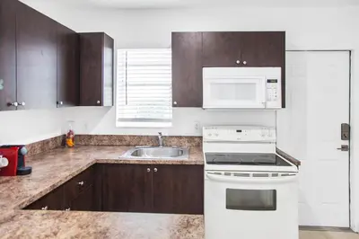 a kitchen with a white stove and a sink at Buena Vista-Miami Designer Apartment # 3 in Miami