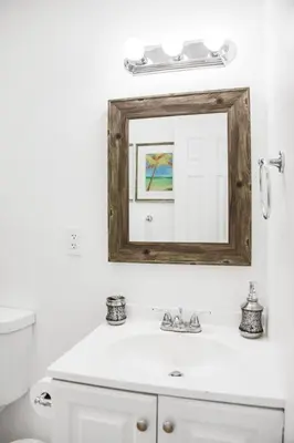 a bathroom with a mirror above a white sink at Buena Vista-Miami Designer Apartment # 3 in Miami