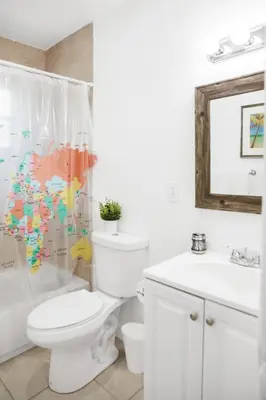 a bathroom with a toilet and a shower curtain at Buena Vista-Miami Designer Apartment # 3 in Miami