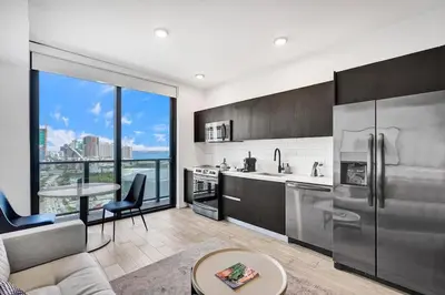 a kitchen with stainless steel appliances and a large window at Lux Studio Miami and Bay views in Miami