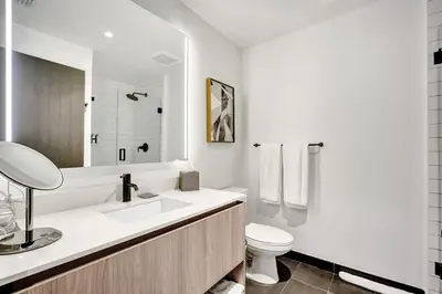 a white bathroom with a sink and a toilet at Lux Studio Miami and Bay views in Miami