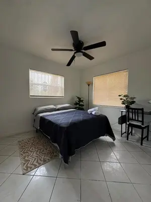 a bedroom with a bed and a ceiling fan at Layover Miami International Airport in Miami