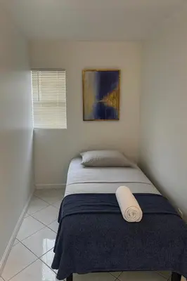 a bedroom with a bed with a towel on it at Layover Miami International Airport in Miami