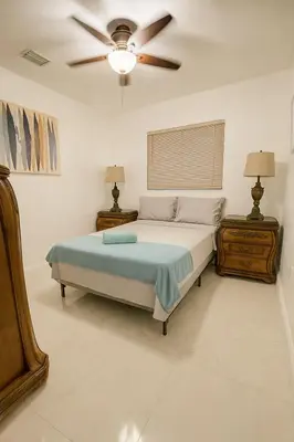 a bedroom with a bed and a ceiling fan at Layover Miami International Airport in Miami