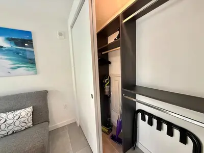 a room with a closet with a couch at Stunning City Views Studio Gym Pool in Miami