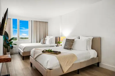 a large bedroom with two beds and a window at Studio Residence at Roney -1128 in Miami Beach