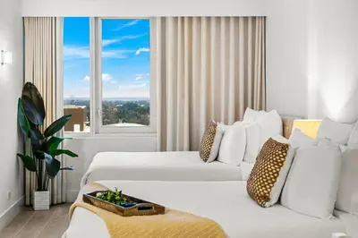 a hotel room with two beds and a large window at Studio Residence at Roney -1128 in Miami Beach