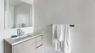 a white bathroom with a sink and a mirror at The Juliet IV Vibe 8697 in Miami