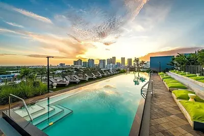 a pool on top of a building with a city skyline at The Juliet V Vibe 8700 in Miami