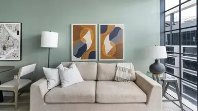 a living room with a couch and some paintings at The Juliet V Vibe 8700 in Miami