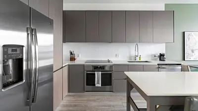 a kitchen with stainless steel appliances and a table at The Juliet V Vibe 8700 in Miami