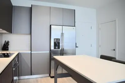 a kitchen with a refrigerator and a table in it at The Juliet VI Vibe 8701 in Miami