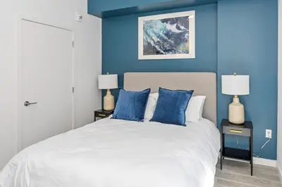 a bedroom with blue walls and a bed with blue pillows at The Juliet VII Vibe 8702 in Miami