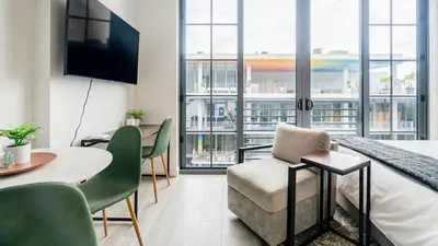 a hotel room with a bed and a table and chairs at The Juliet IX Vibe 8707 in Miami