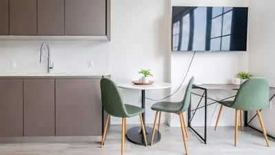 a kitchen with green chairs and a table at The Juliet IX Vibe 8707 in Miami