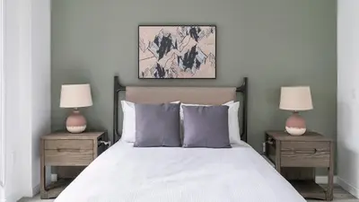a bedroom with a large bed with two lamps on tables at The Juliet X Vibe 8741 in Miami