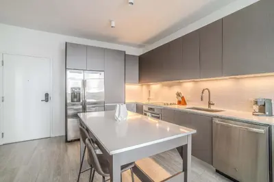 a kitchen with a white table and a refrigerator at The Juliet XI Vibe 8744 in Miami