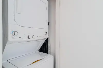 a white refrigerator freezer sitting next to a door at The Juliet XI Vibe 8744 in Miami