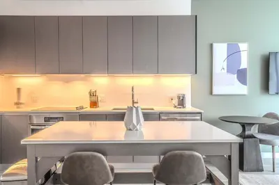 a kitchen with a table and some chairs and cabinets at The Juliet XI Vibe 8744 in Miami