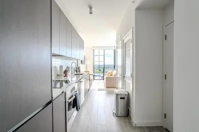 a kitchen with white cabinets and a white floor at The Juliet XII Vibe 8745 in Miami