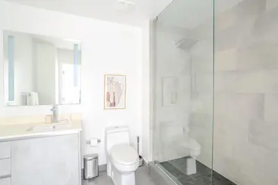 a bathroom with a toilet and a glass shower at The Juliet XII Vibe 8745 in Miami