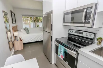 a kitchen with a stove and a microwave at Mimo Bungalows By Renzzi in Miami