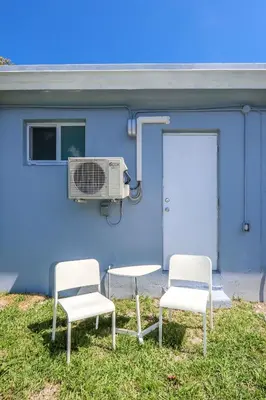 two chairs and a air conditioner next to a building at Mimo Bungalows By Renzzi in Miami