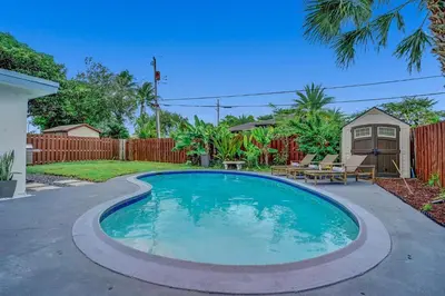 a swimming pool in the backyard of a home at Newly Renovated w Heated Saltwater Pool & Hot Tub in Hollywood