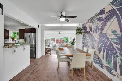a kitchen and dining room with a table and chairs at Newly Renovated w Heated Saltwater Pool & Hot Tub in Hollywood