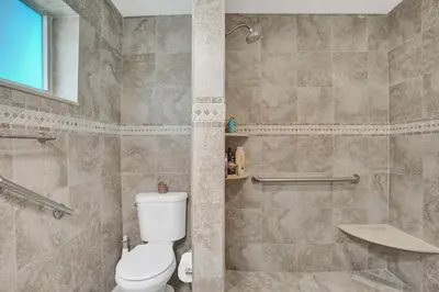 a bathroom with a toilet and a shower at Newly Renovated w Heated Saltwater Pool & Hot Tub in Hollywood