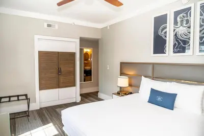 a bedroom with a large white bed and a window at San Juan Hotel Miami Beach in Miami Beach